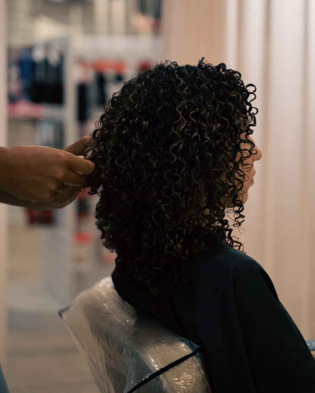 Customer with Curly Hair Getting Their Hair Styled at Take Khair Beauty Hair Salon in Toronto